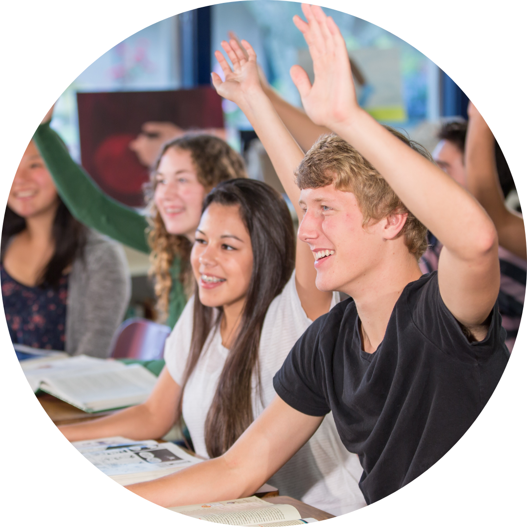 teens in class with hands raised